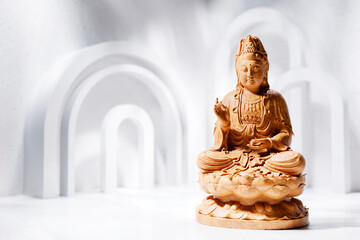 Wooden buddha statue in minimalist white background
