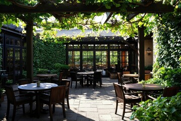 Fototapeta premium Outdoor Patio with Wooden Tables and Chairs under a Leafy Vine Covered Pergola