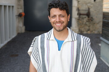 Hispanic man wearing a poncho