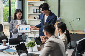 Group of Young Asian business team creative businesspeople coworker in office. Meeting Presentation for analysis graph company financial. People Work in Business Office.