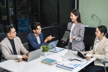 Group of Young Asian business team creative businesspeople coworker in office. Meeting Presentation for analysis graph company financial. People Work in Business Office.