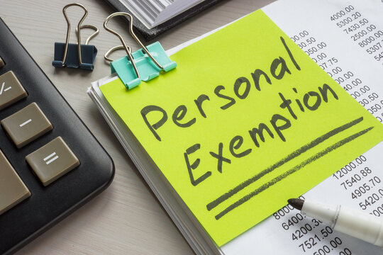 Report, calculator and label personal exemption. Symbolizes tax deductions.