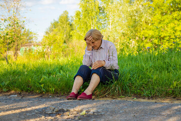 Old woman feels bad on the street, headache. Selective focus.