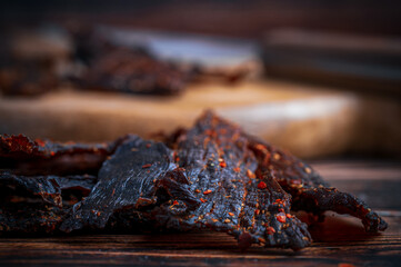Traditional Beef Jerky Served on Wooden Board with Knife