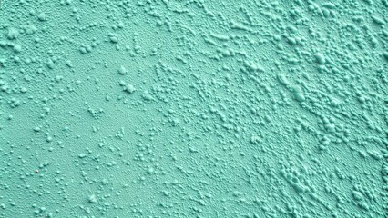Textured mint green wall surface for backgrounds in creative projects