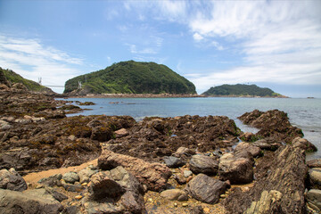 Eroded and twisted beach rocks against a bridge on the sea at Bangchukdo Island near Gunsan-si, South Korea