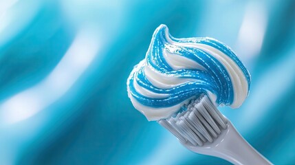 A close-up of a toothbrush with a perfect swirl of blue-and-white striped toothpaste on the bristles, ready for brushing.