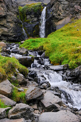 Cascading mountain stream with a waterfall in Iceland. Beautiful mountain river