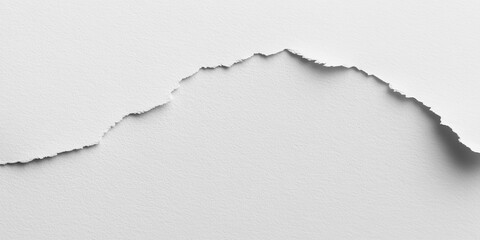 A close-up of torn white paper creating a textured, abstract landscape.