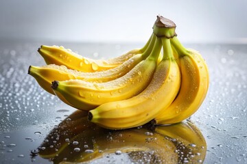 Fresh Ripe Bananas with Water Droplets on Reflective White Surface Against Soft Neutral Background