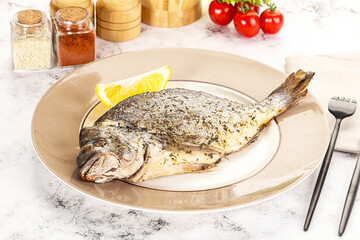 Baked Dorado fish served lemon