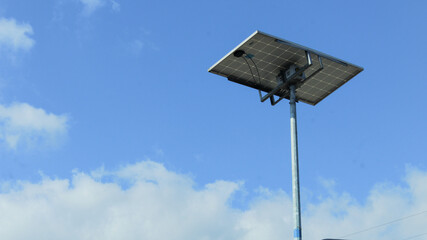 Solar panels on street light poles with blue sky background