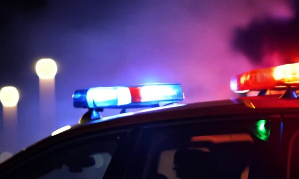 Police car siren flashing blue and red in the dark, emergency vehicle