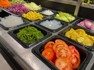 Fresh, vibrant assortment of vegetables arranged neatly for salad preparation, showcasing a healthy culinary selection.