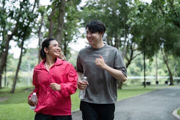 Happy Couple Jogging in the Park During Workout Session, Staying Fit and Healthy Outdoors