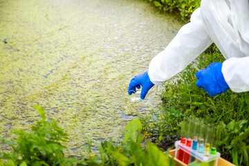 Take a water sample from the river. Selective focus.