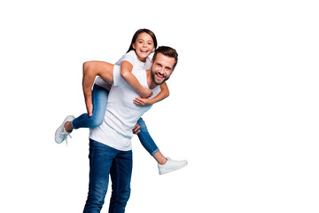 Portrait of cheerful people laughing piggyback wearing white t-shirt denim jeans isolated over blue...