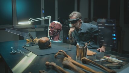 Advanced archaeological lab: Mature archaeologist in VR headset studies ancient human anatomy in augmented reality using fossil skull. 3D graphics of virtual display with software user interface. VFX