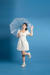Portrait of beautiful Asian woman posing on blue background.