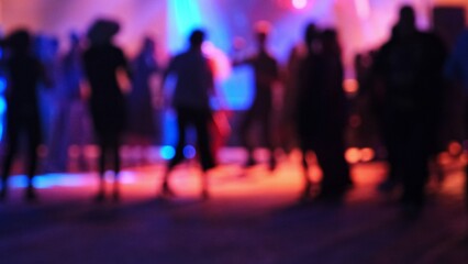 Blurry Silhouette of Anonymous Crowd of People Having Fun Dancing on Disco Dance Floor with...