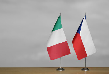 Table flags of Italy and Czech Republic on grey blurred background