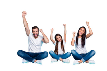 Fototapeta premium Full length body size photo of charming beautiful funny funky family rejoicing with their victory over someone wearing white t-shirts jeans denim while isolated with blue background