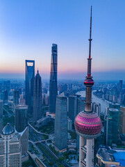 Aerial view of modern city skyline and buildings at sunrise in Shanghai