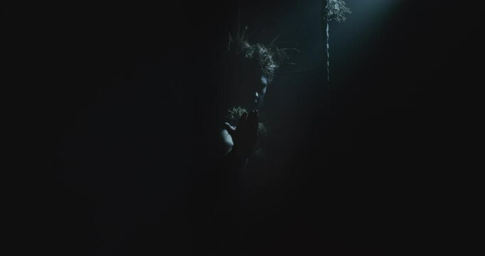 The witch makes a beckoning gesture with her hand