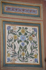 Intricate floral painted wood panel with colorful designs, showcasing traditional Moroccan craftsmanship and vibrant colors in Marrakesh, a beautiful example of Moroccan art and decoration
