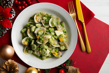 Green beans with clams and hard-boiled egg. Top view table with Christmas decorations.