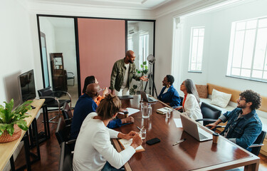 Boardroom meeting with a diverse team discussing business strategies and collaboration