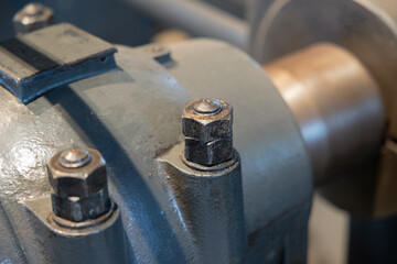 Old pipeline with a flange and screws, connected to a pump. Mechanical connection, pipeline, industrial design, old machine.