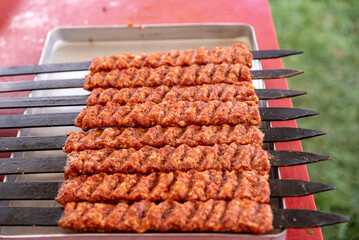 Man hand preparing traditional delicious Turkish shish kebab skewer made of lamb liver.