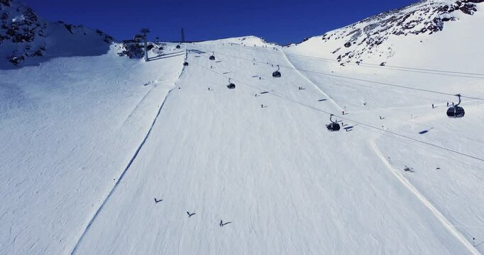 Aerial view footage of beautiful panoramic winter ski track and gondolas in Alps, Solden ski resort, Tyrol, Austria.