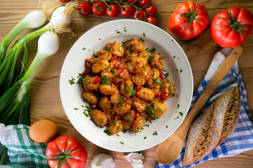 Delicious Italian gnocchi with pesto rosso. Top view table with  decorations.