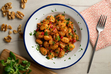 Delicious Italian gnocchi with pesto rosso. Top view table with  decorations.