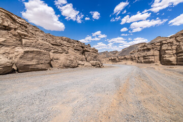 Desert road and Yadan landform natural landscape. Road trip in no man's land.