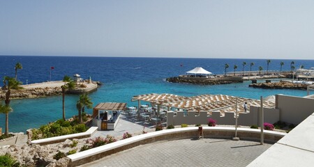 A luxurious and comfortably furnished recreation area on the shores of the Red Sea, landscape design, a bar, an open-air restaurant, a promenade, flower beds and palm trees