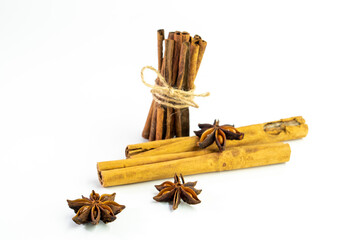 Cut orange and different spices  on white background. Traditional festive winter beverage.Cinnamon, dried orange, anise and cloves