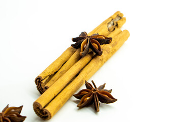 Cut orange and different spices  on white background. Traditional festive winter beverage.Cinnamon, dried orange, anise and cloves