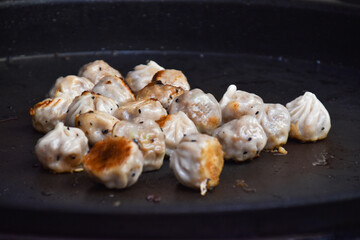 Asian street food fried dumplings being rotated crips and golden brown