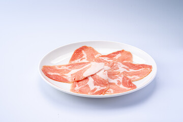Freshly Sliced Raw Pork on White Plate
