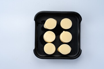 Creamy Yellow Discs on Black Tray