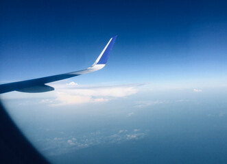 Tourism Aspiration Concept - Sky view of wing from Airplane Window - Stock Image