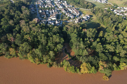 Mudy waters of flooded Catawba river nearly encroach on Rock Hill community in South Carolina after hurricane Helene