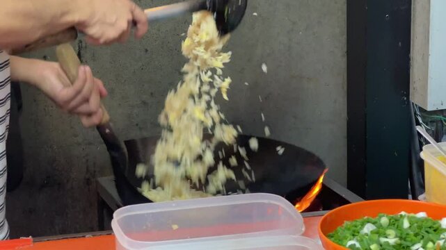  30 September 2024 Bang Saen Beach, Chonburi : People are skillfully frying fried rice.