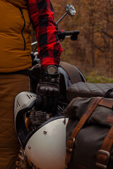 The motorcyclist's hand is holding a helmet