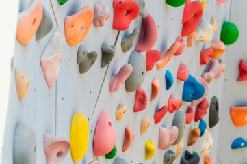 Climbing wall with climbing holds of different colors and shapes © Semiglass