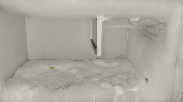the refrigerator freezer is full of frozen ice