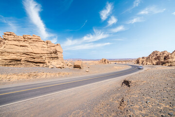 Asphalt road highway and Yadan landform natural landscape under blue sky. Car background.